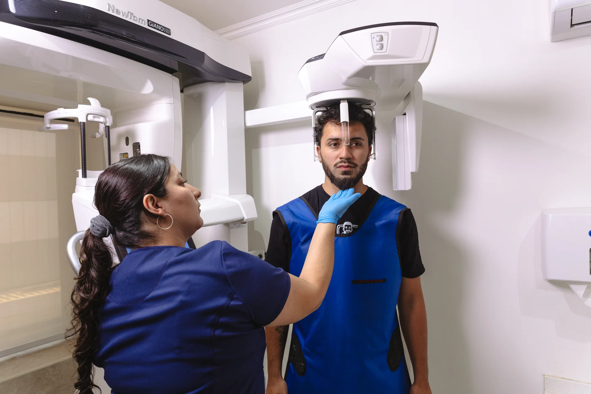 Técnica de i-maxval posicionando a un paciente en el equipo de radiografía panorámica en Valdivia
